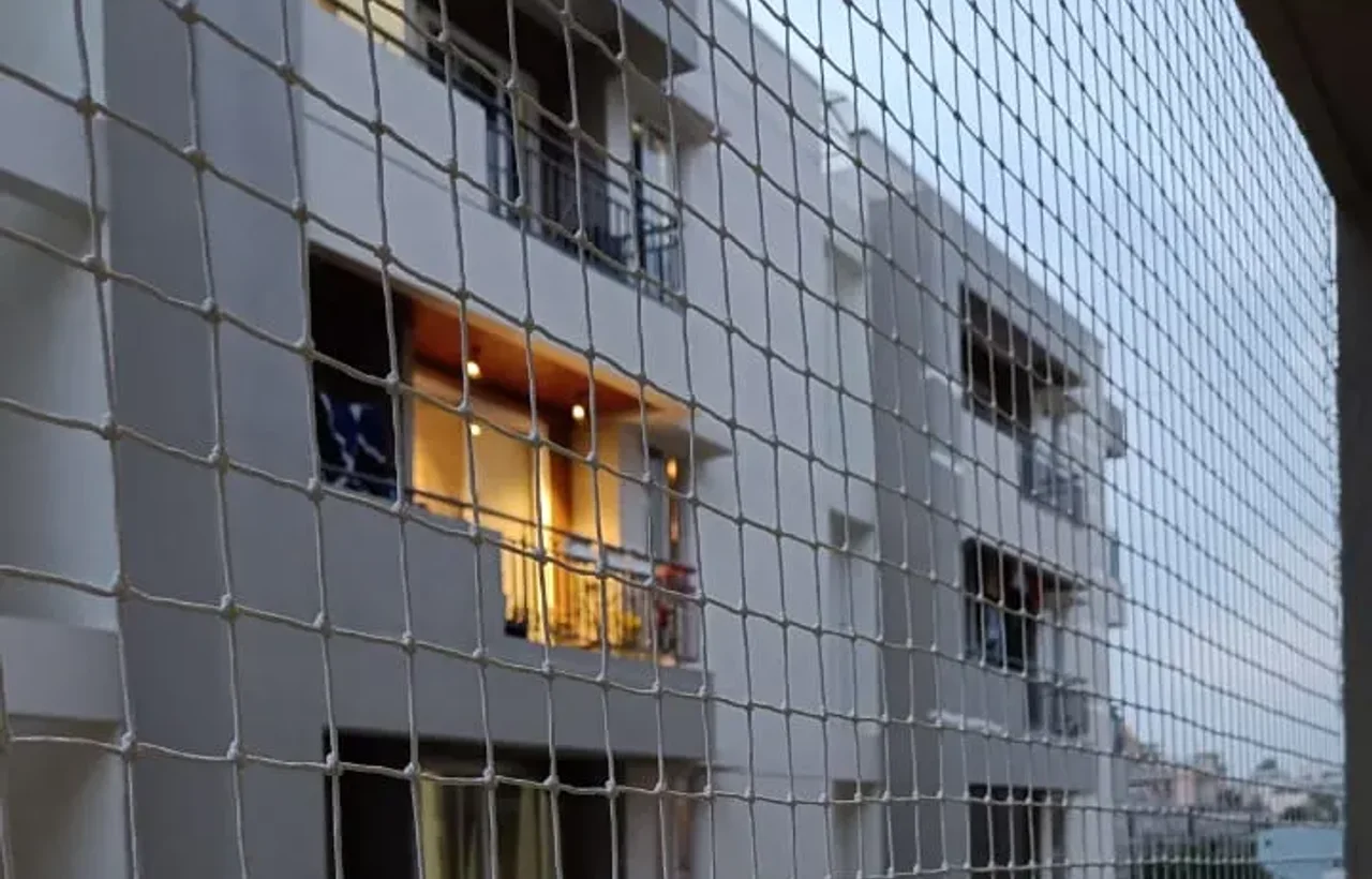 Safety netting across a full apartment elevation, several floors covered
